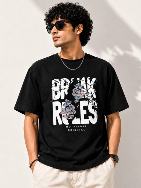 Man wearing a black oversized t-shirt with the Break Rules print
